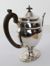 A large and heavy hallmarked silver coffee pot in 18th century style (later): high carved wooden