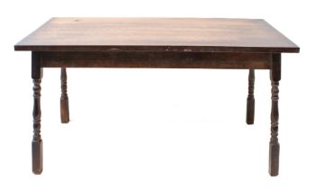 An early 20th century oak centre table: the overhanging rectangular top above four turned and