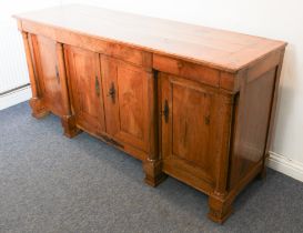 A 19th century French cherrywood buffet - the cleated, three-plank top over three baize lined frieze