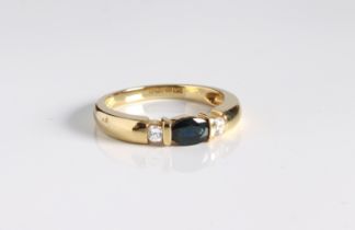 An 18ct yellow gold, sapphire and CZ three stone ring - Sheffield hallmarks, the central oval cut