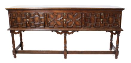 A fine reproduction solid oak sideboard in late 17th century style: the moulded top above three