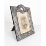 An Elizabeth II silver photo frame - maker JC, London 2000, rectangular with cartouche cresting,