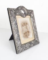 An Elizabeth II silver photo frame - maker JC, London 2000, rectangular with cartouche cresting,