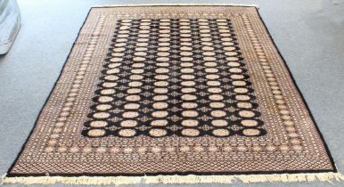 A late 20th or early 21st century Pakistan Bohkara carpet; dark-blue ground with a Turkmen-style