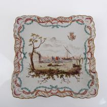 A French hand-painted porcelain armorial plate - of rounded, square form, with harbour scene and