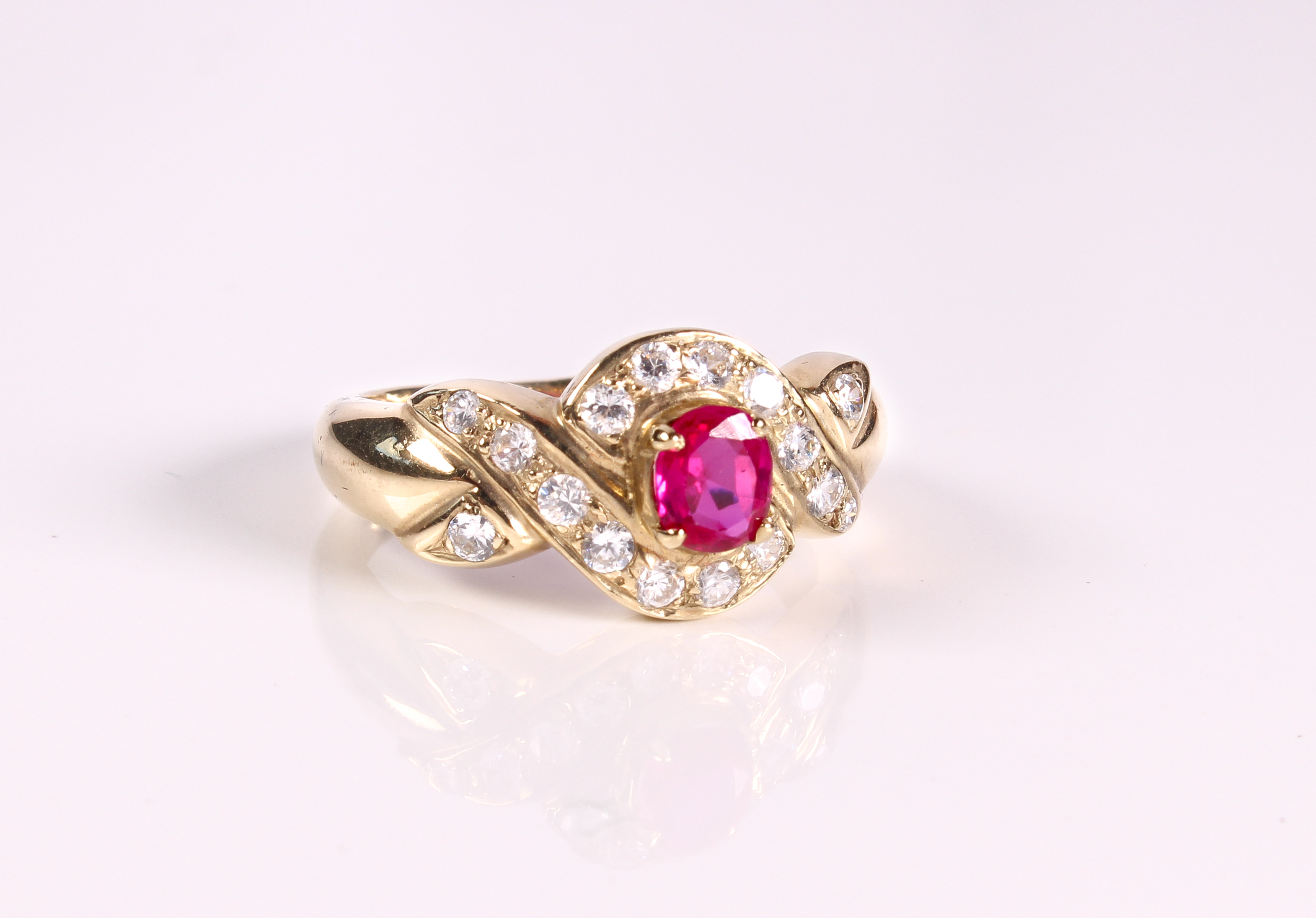 A 9ct yellow gold, pink and clear stone cluster ring - Sheffield hallmarks, with cross over setting,