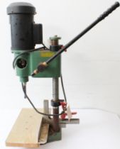 A Mekita chop saw 2414NB, together with a hand-operated electric drill and a Performance bench