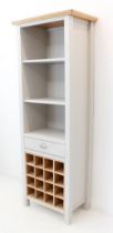 A modern and stylish shelving unit of slim proportions: the natural oak top above shelves, a full