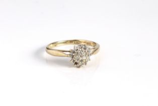 A 9ct yellow gold and diamond cluster ring - Sheffield hallmarks, with a domed circular cluster of