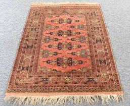 A mid-20th century hand-knotted North-West Persian rug: four stylised lozenges against a red