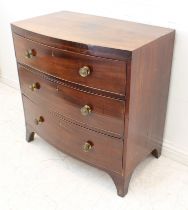 An early 19th century mahogany bowfront caddy-topped chest of small proportions: three full-width