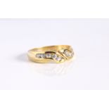 A 9ct yellow gold and white sapphire crossover ring - hallmarked Sheffield 2003, the twist setting