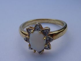 A silver gilt dress ring: centrally mounted with an oval opal (boxed), ring size R