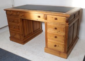 A modern pine double pedestal desk with inset leather and 3 freize drawers, on plinth bases. (LWH 80