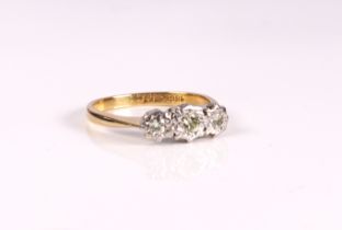 An 18ct yellow gold and diamond trilogy ring - stamped '18CT', with three graduated brilliant cut