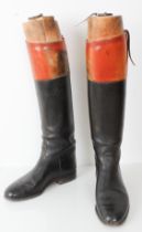 A pair of gentleman's black and tan hand-stitched leather riding boots, together with original