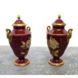 A pair of boxed Wedgwood Ruby Tonquin two-handled vases and covers - printed factory marks, of urn