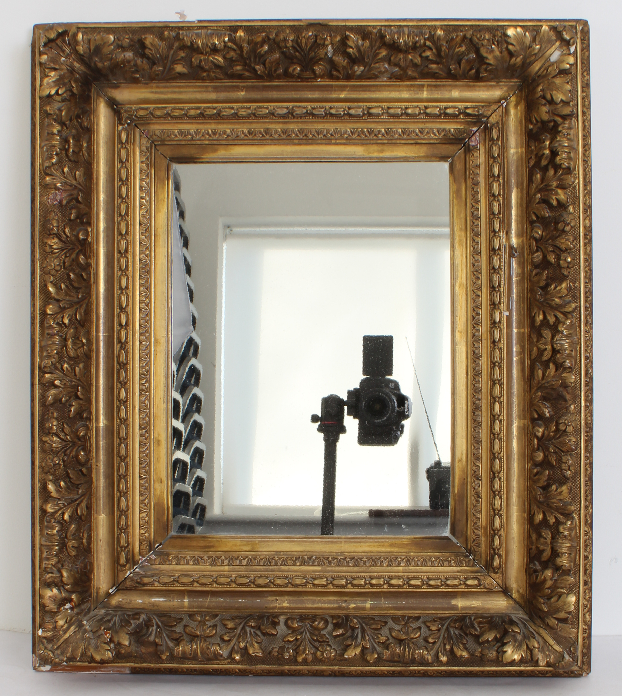 A 19th century gilt and composition picture frame mirror - the later plate within an acanthus and