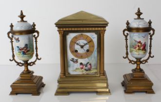 A French Japy Freres gilt brass and porcelain three-piece ornithological subject clock garniture -