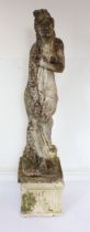 A large composite stone garden sculpture of a classical female figure - on a separate, square fluted