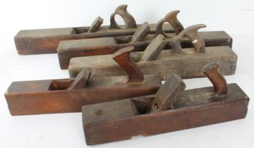 Five antique beech wood woodworking block planes - three 66cm. long, one by Ames of Westminster, one