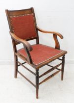 A 19th century beech, ash and fruitwood open armchair: concave tablet-shaped top rail above an
