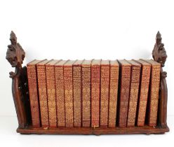 A Victorian carved oak Gothic Revival extending tabletop bookshelf - the shelf holding fourteen gilt