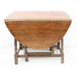 A mid-20th century oval-topped oak dropleaf gateleg table on baluster turned supports (LWH 135.5 (