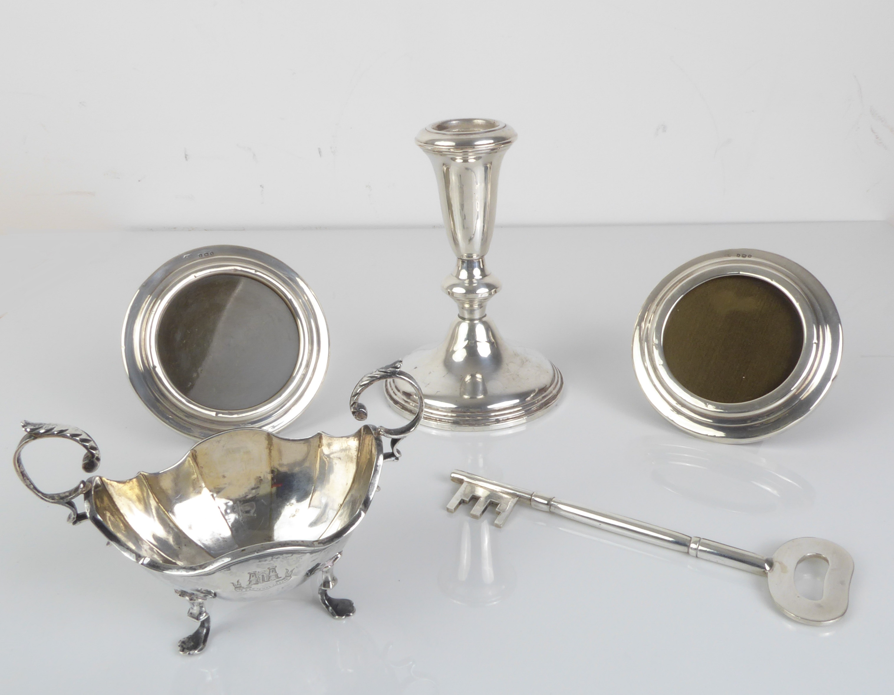 A silver selection to include - a pair of small circular hallmarked silver easel-style photograph