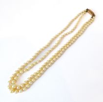 A vintage two-strand cultured pearl necklace - the pearls sized from 3mm to 7mm diameter, with