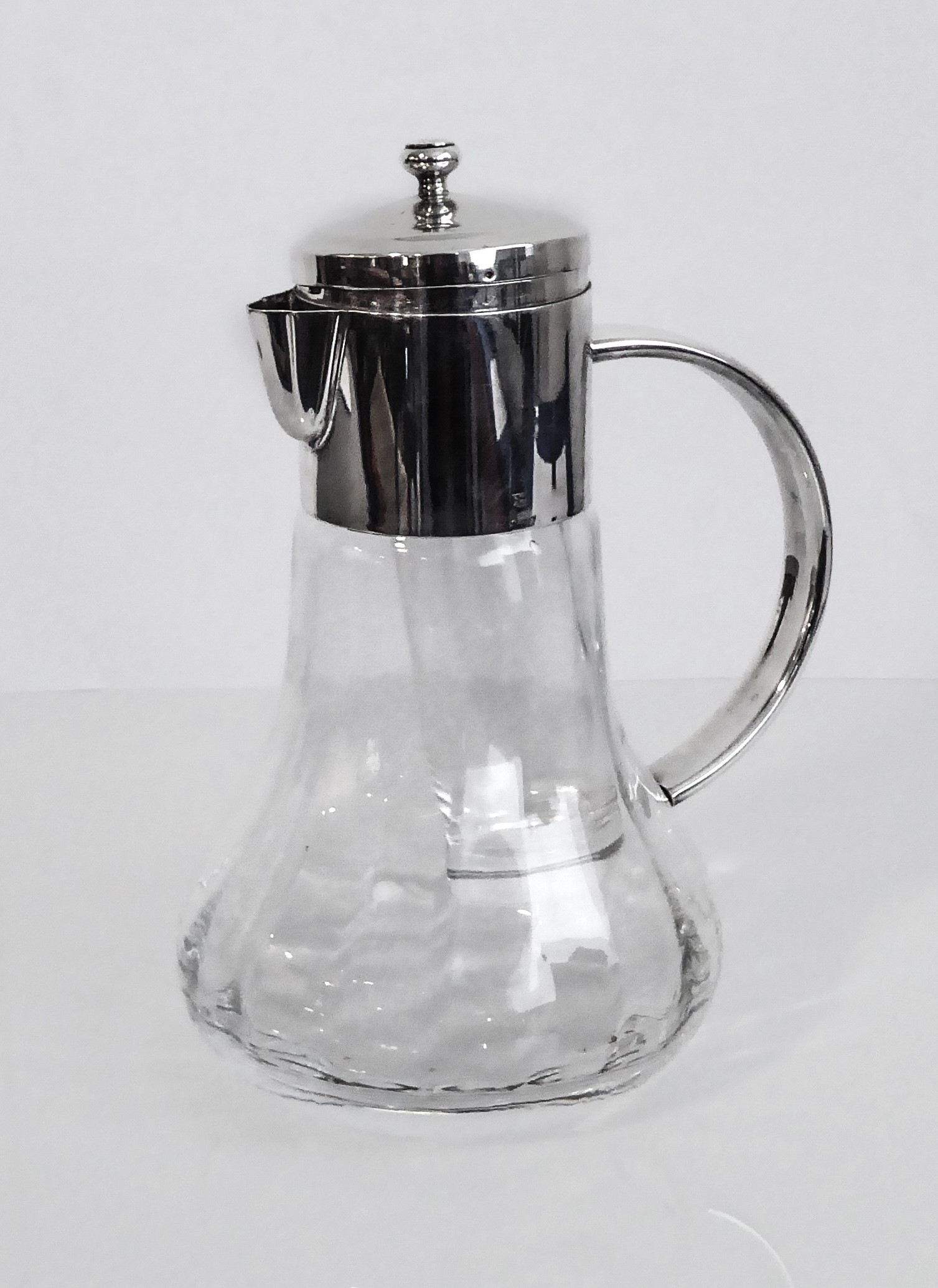 A large silver-plated glass wine jug with interior glass removable ice compartment marked Asprey.