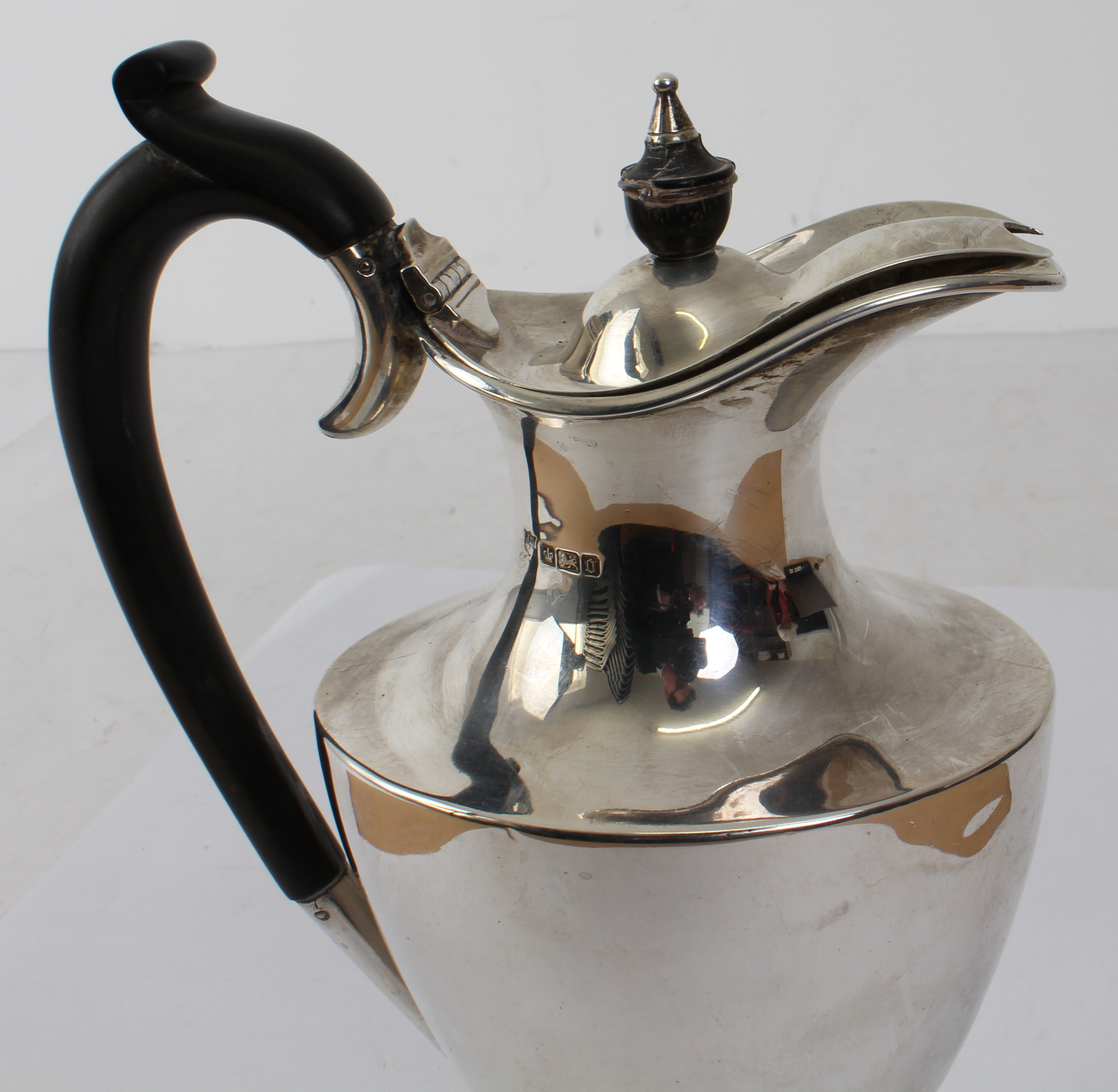 A hallmarked silver water jug in High Neoclassical style: high arched carved ebony handle above a - Image 2 of 2