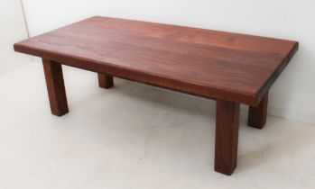 A modern teak handmade coffee table: rectangular top with bevelled edge; raised on plain square