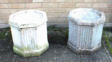 A pair of composite stone garden planters - of octagonal fluted form, with attractively well-