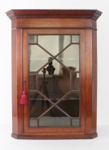 A small Edwardian mahogany corner cupboard in the George III style - flared moulded cornice, 13-pane