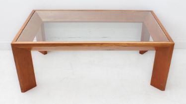 A mid-century style glass-topped coffee table with satinwood base and with angular legs (LWH 100 x