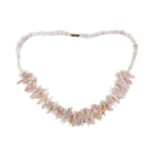 A pale pink coral fringe necklace - with screw clasp, 46cm. long, with presentation box.