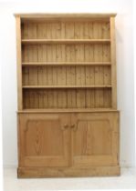 A pine dresser in 19th century style - the moulded cornice above a shelved superstructure locating