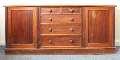 A 19th century mahogany sideboard of country house proportions: the moulded top above a central