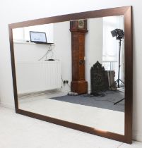 A large and modern rectangular mirror with dark wooden frame (LW 197 x 136 cm).