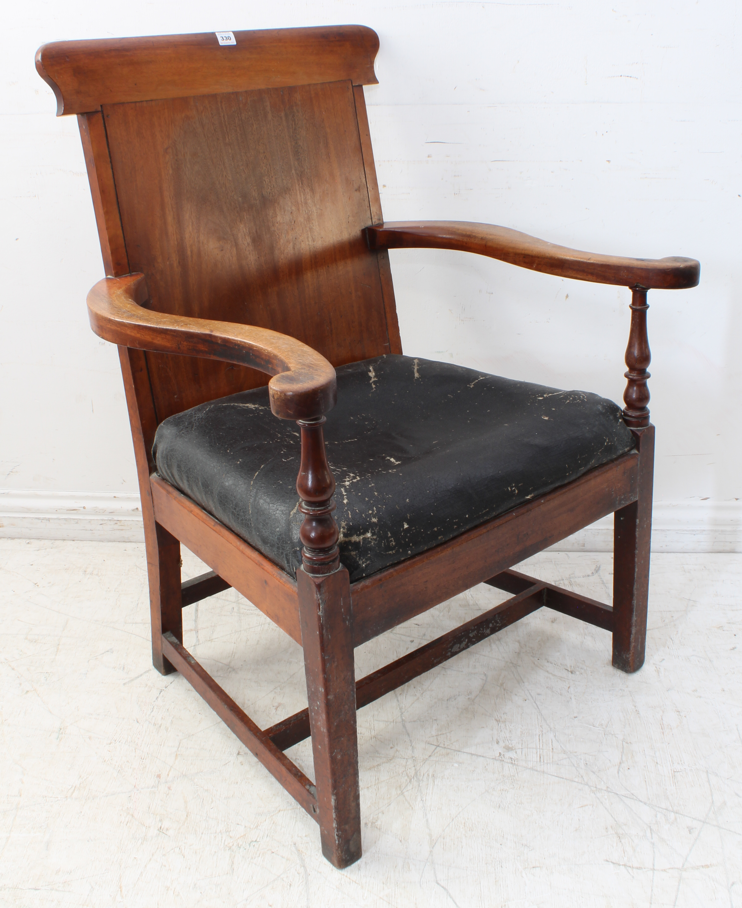 An oversized late Georgian or early Victorian mahogany open armchair: shaped top rail, outset