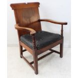 An oversized late Georgian or early Victorian mahogany open armchair: shaped top rail, outset