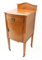 An early 20th century bow-fronted, satinwood pot cupboard in late 18th century Sheraton Revival