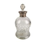 An early 20th century cut-glass ovoid decanter with silver-mounted collar and (probably later)