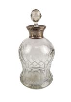 An early 20th century cut-glass ovoid decanter with silver-mounted collar and (probably later)