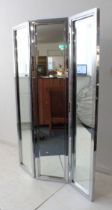 A two-fold steel framed mirror fronted room screen (LH 127 x 180.5 cm).