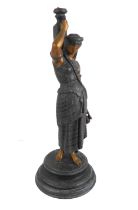 A late 19th century figural spelter candlestick modelled as an Eastern style female figure