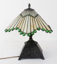 A Tiffany-style table lamp with cast-iron base