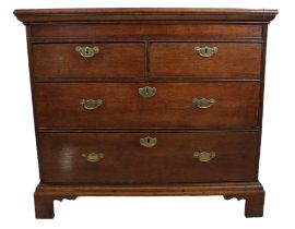 An early 18th century oak chest of small proportions - two-plank cleated moulded top, two half-width