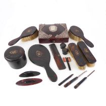 An early 20th century lady's tortoiseshell and gilt metal inlaid (monograms) dressing table set